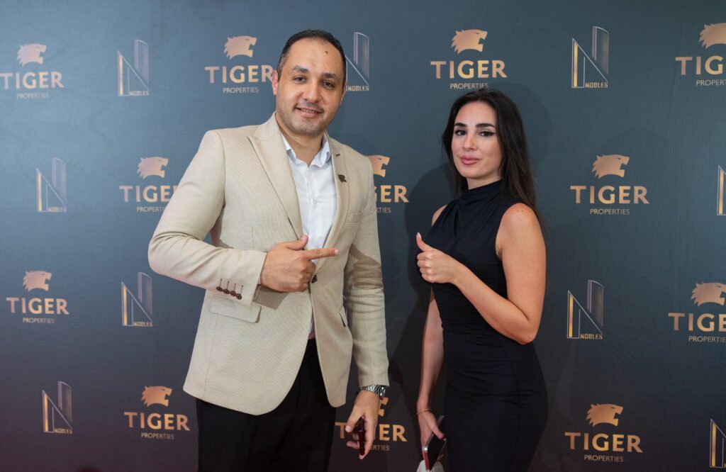 Photo of a couple near a media wall in a event